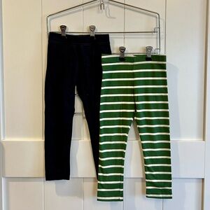 Two pairs of Primary leggings, black and green with white stripes